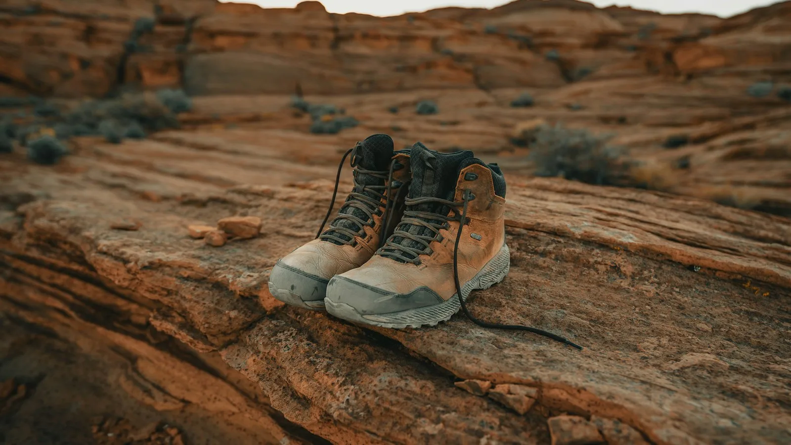 Chaussures de randonnée montantes posées sur un terrain rocheux désertique